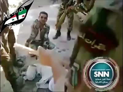Soldiers torture alleged Syrian rebel.