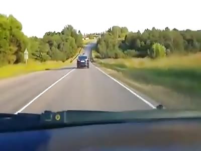 Close Call as a Russian Scooter Driver Drives Straight Towards Incoming Traffic