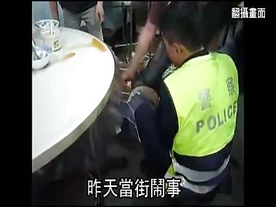 POLICE HOLDING CHINESE LUNATIC