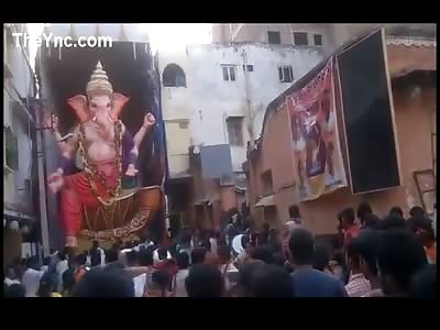 Ganesha statue falling down during religious festival in India. 