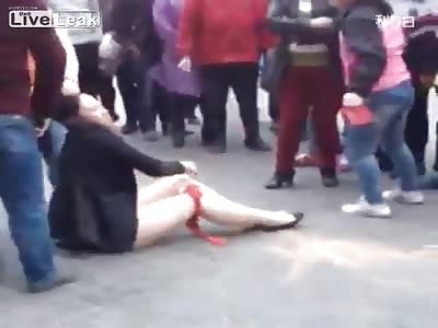 Chinese woman stripped naked in public and beaten by three other Chinese women