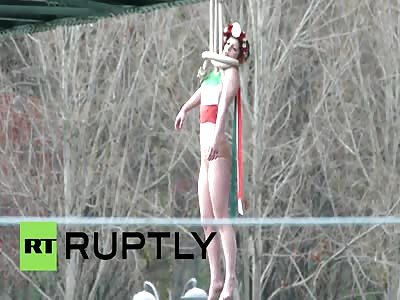 Topless FEMEN 'hangs' herself on Paris bridge to protest Rouhani's visit