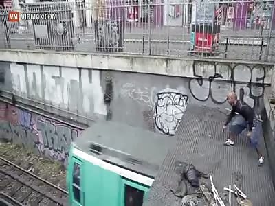 Crazy French guy jumps onto of moving train in Paris.