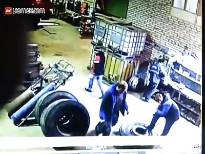 Mechanic gets taken out by a tire exploding